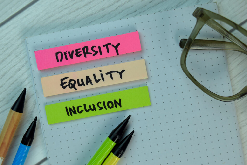 Diversity Equality Inclusion write on a sticky note isolated on Office Desk.